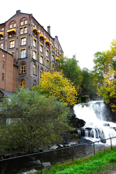 A brick building on Akerselva river and waterfall.