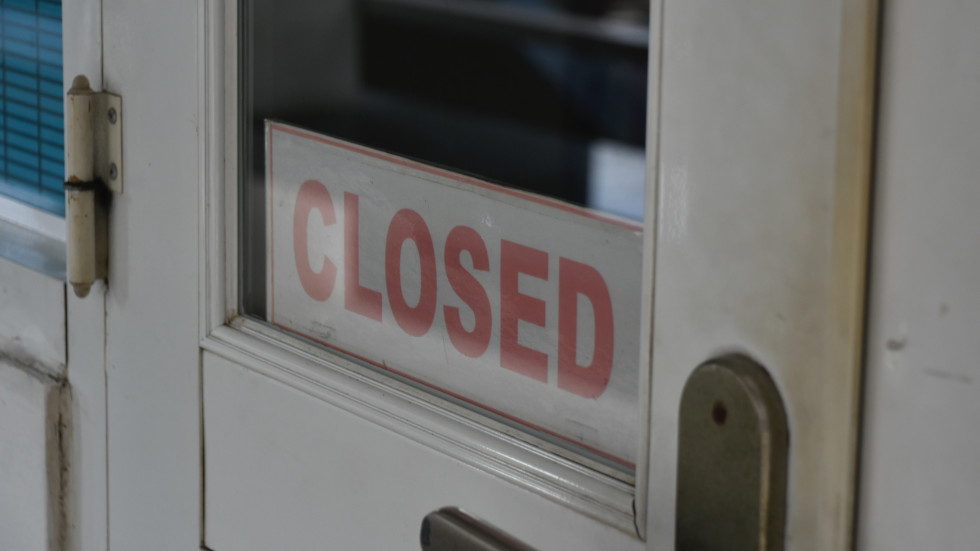 A door with a closed sign showing