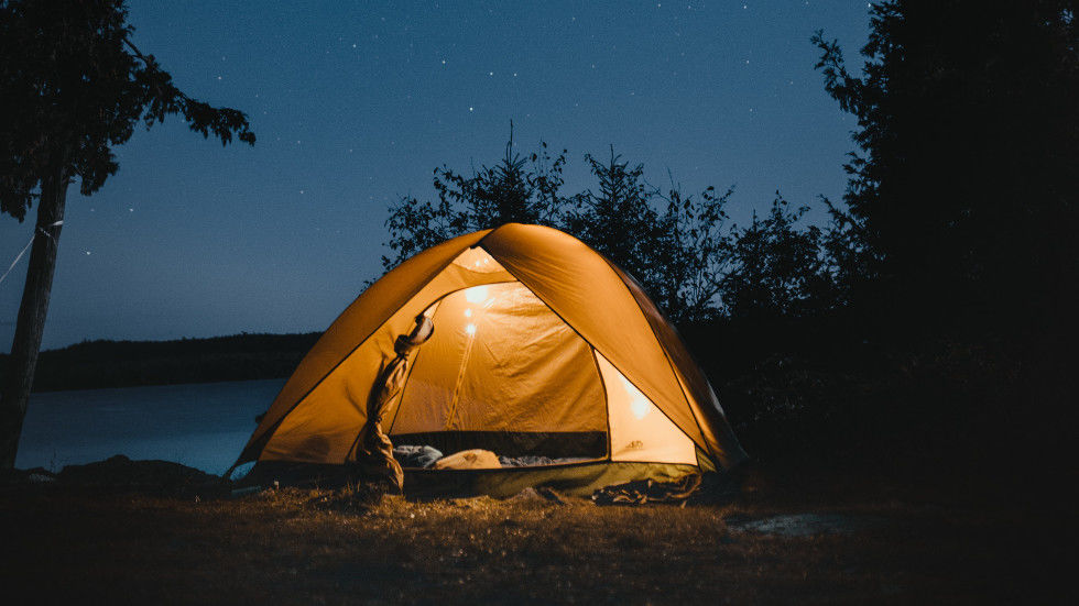 Tent by a lake at night, like the one Ruari is sitting in as he writes this