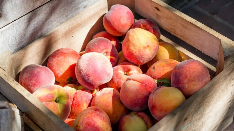 Peaches in a wooden crate