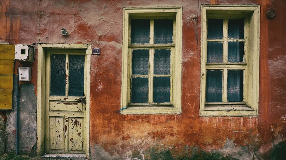 An old house with external damage from wear and tear.