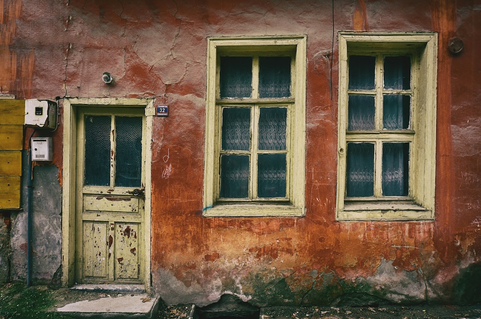 An old house with external damage from wear and tear.